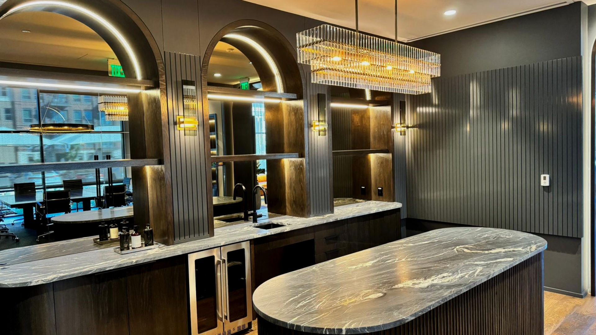 Multifamily clubhouse bar with arched fluted wood millwork