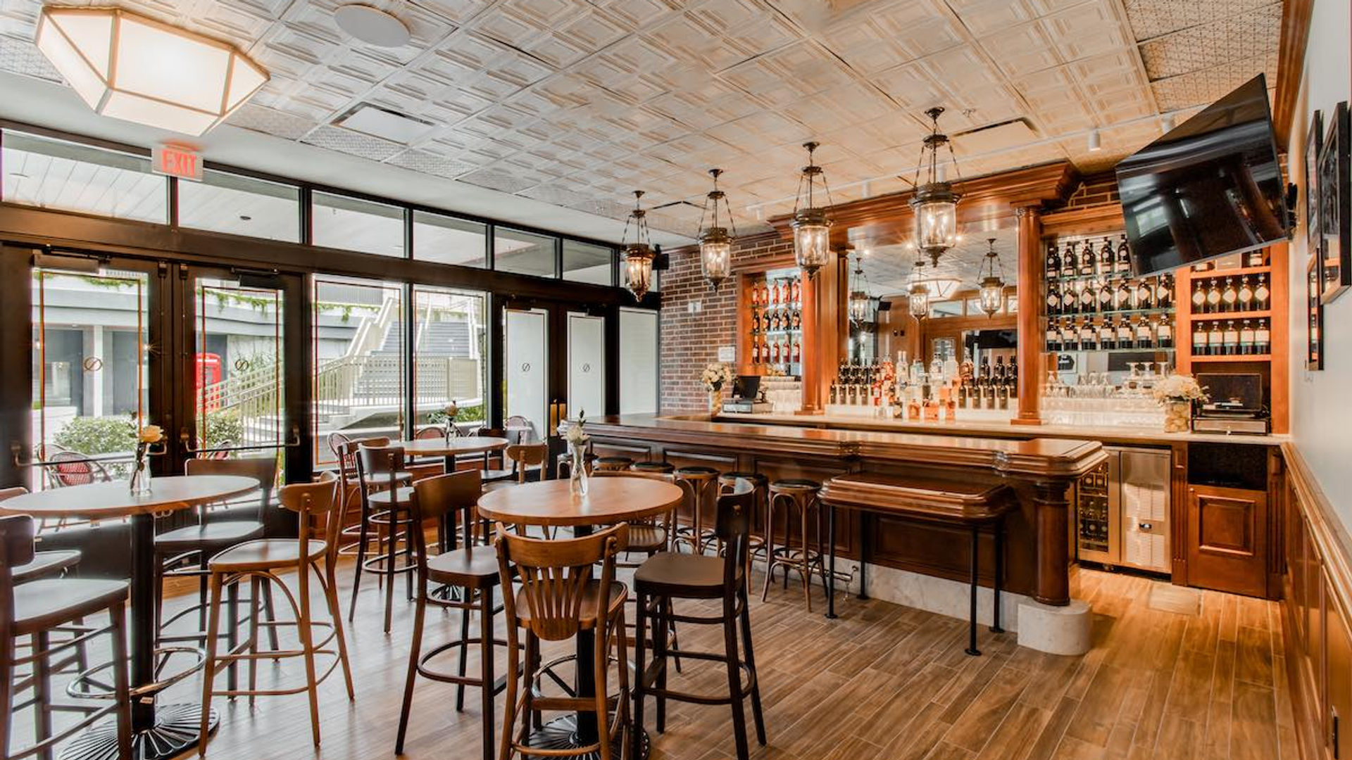 Hotel bar with custom wood millwork and pressed-tin ceiling