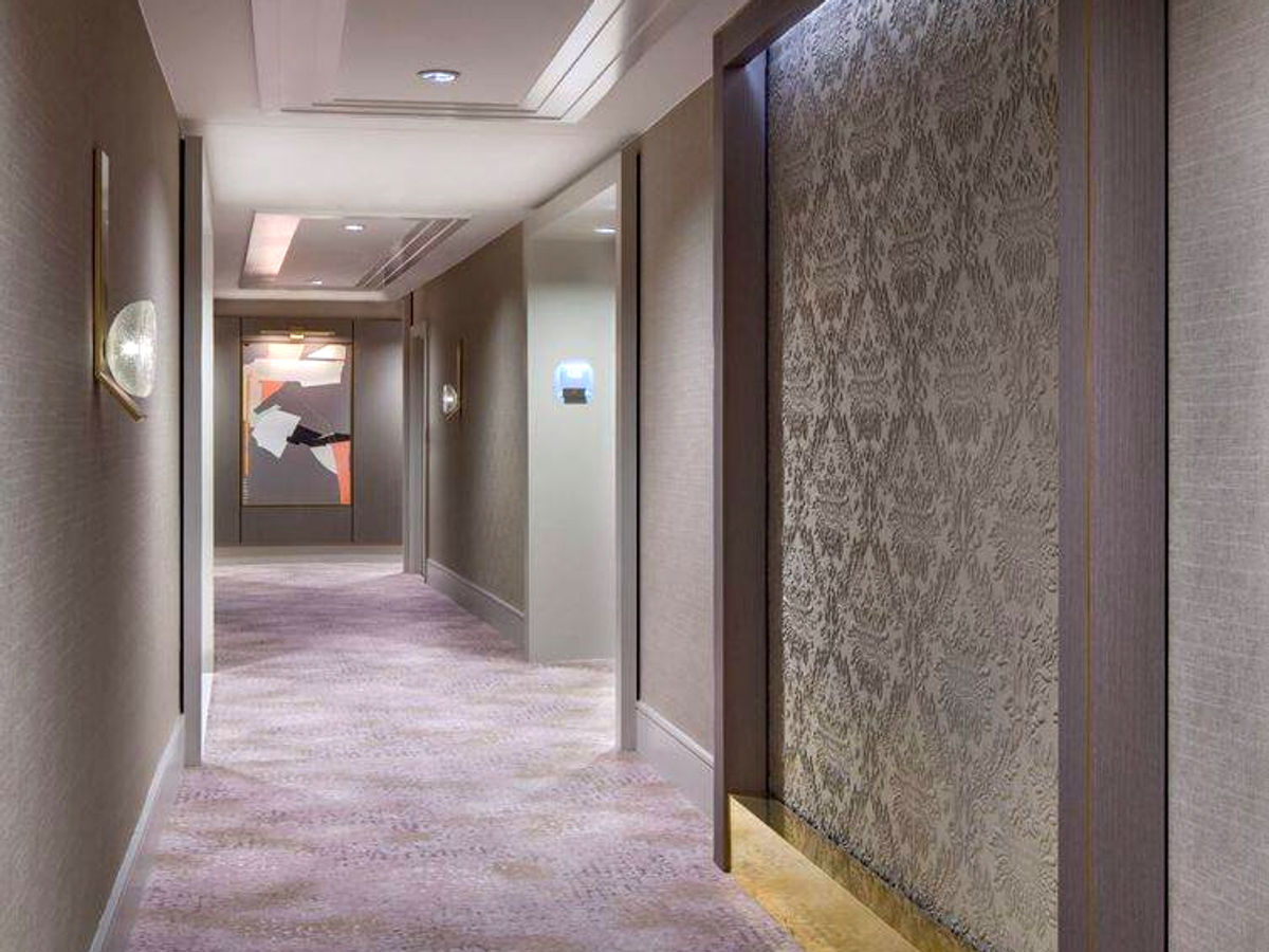 Hotel corridor with custom textured wall panel millwork