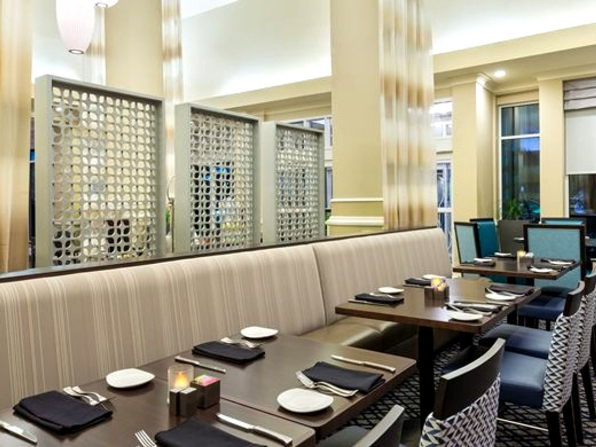 Hotel restaurant booth with decorative wood screen dividers
