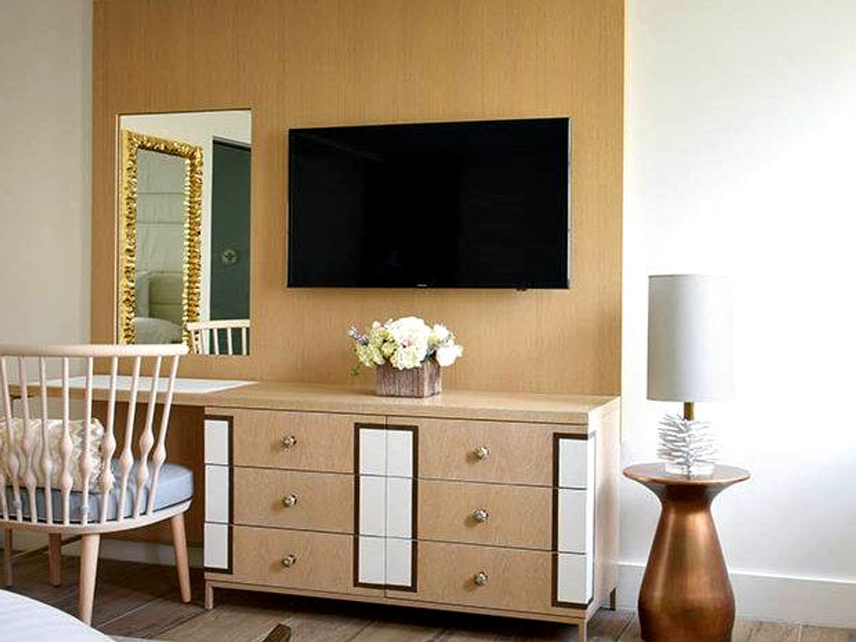 Multifamily model unit bedroom with a custom wood wall panel