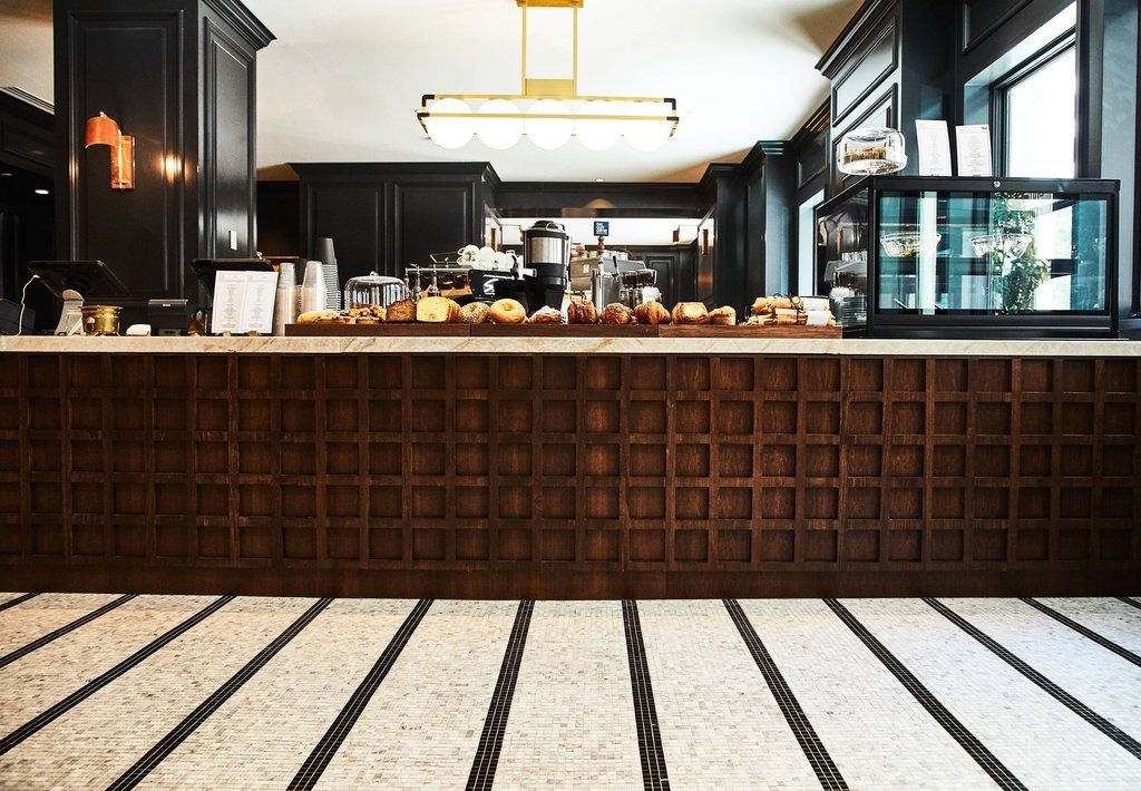 Café counter with a custom wood waffle-panel millwork facade