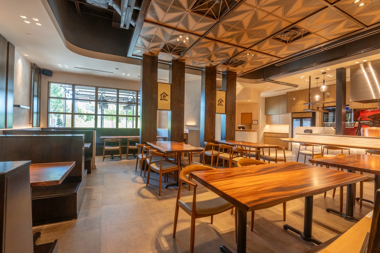 Restaurant dining room with a geometric wood ceiling pattern