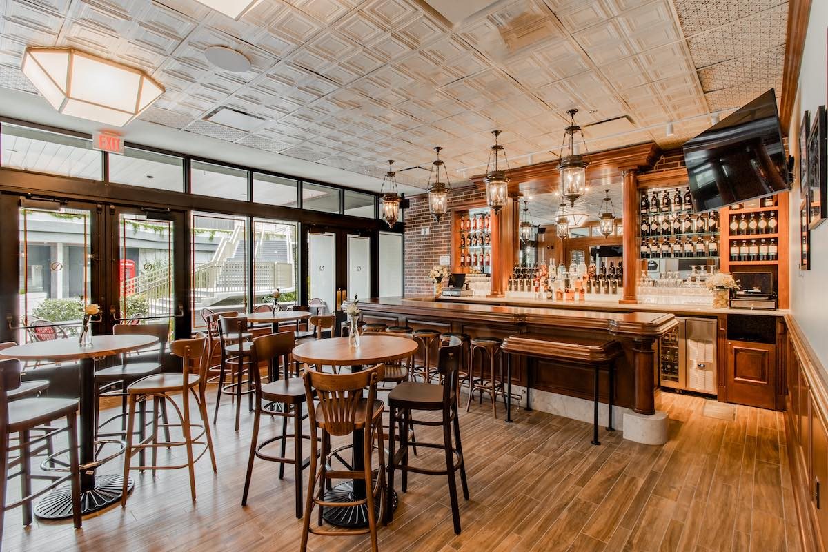 Restaurant bar with reclaimed tin ceiling and custom wood millwork