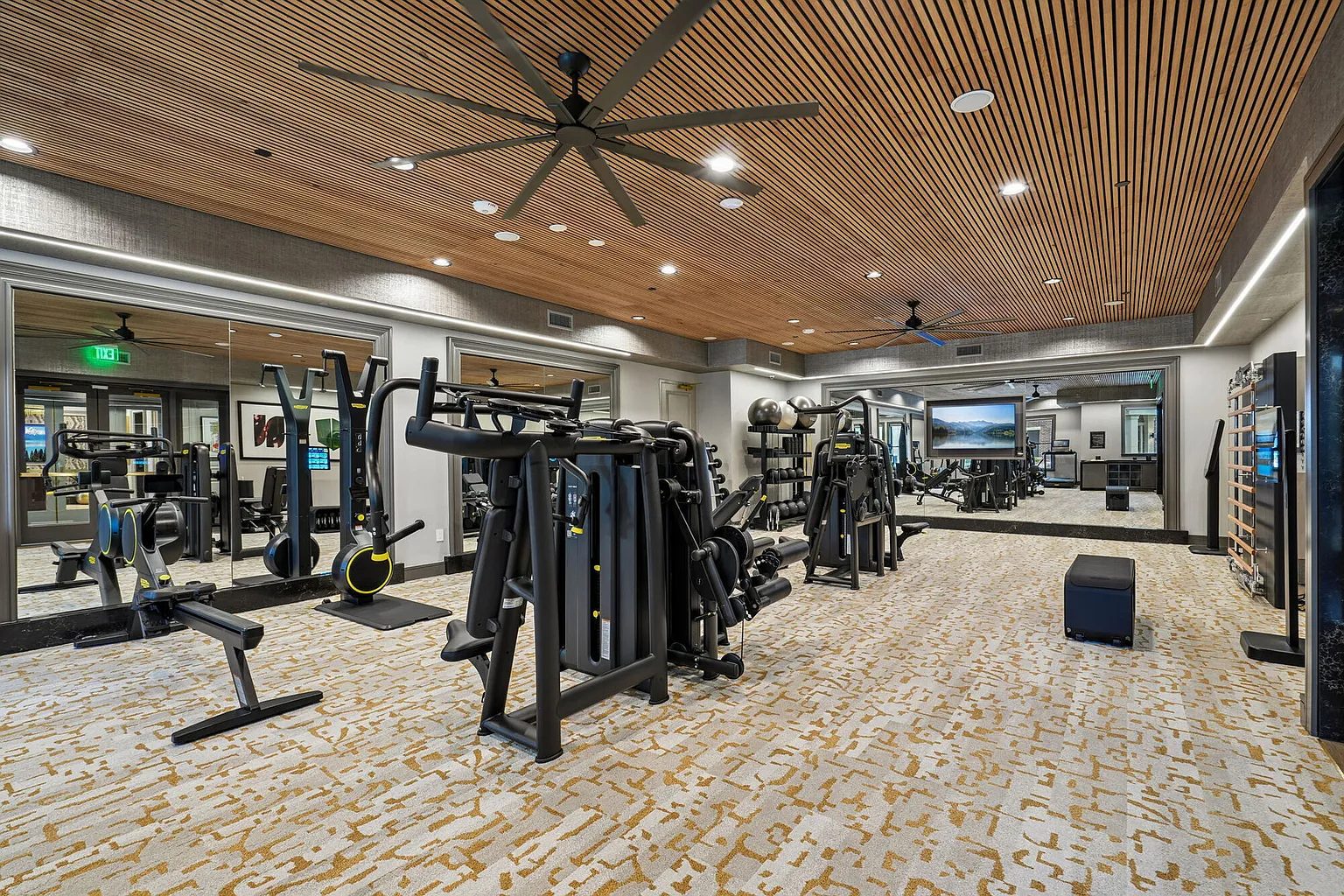Multifamily amenity fitness center with wood slat ceiling millwork